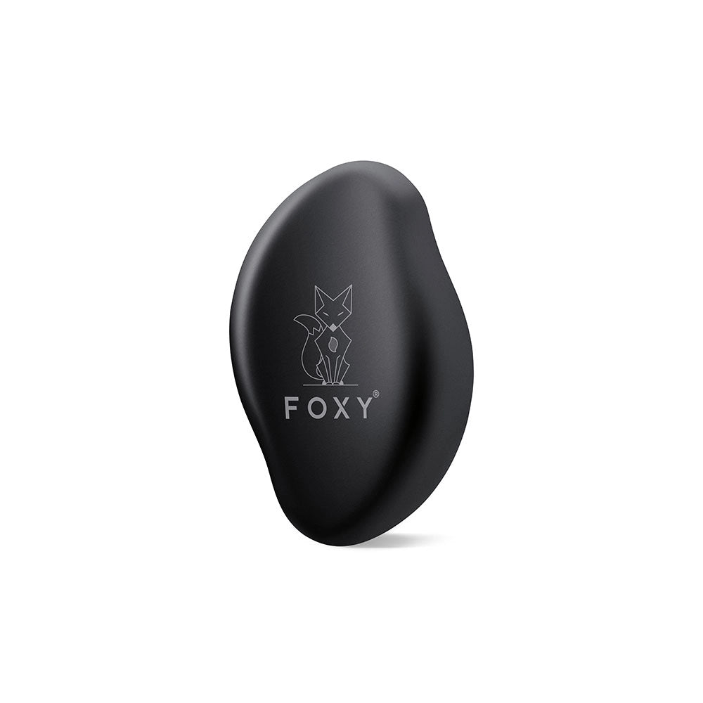 Black, Matte, Oval-shaped hair removal tool with a stylized fox logo and the word FOXY printed on it.