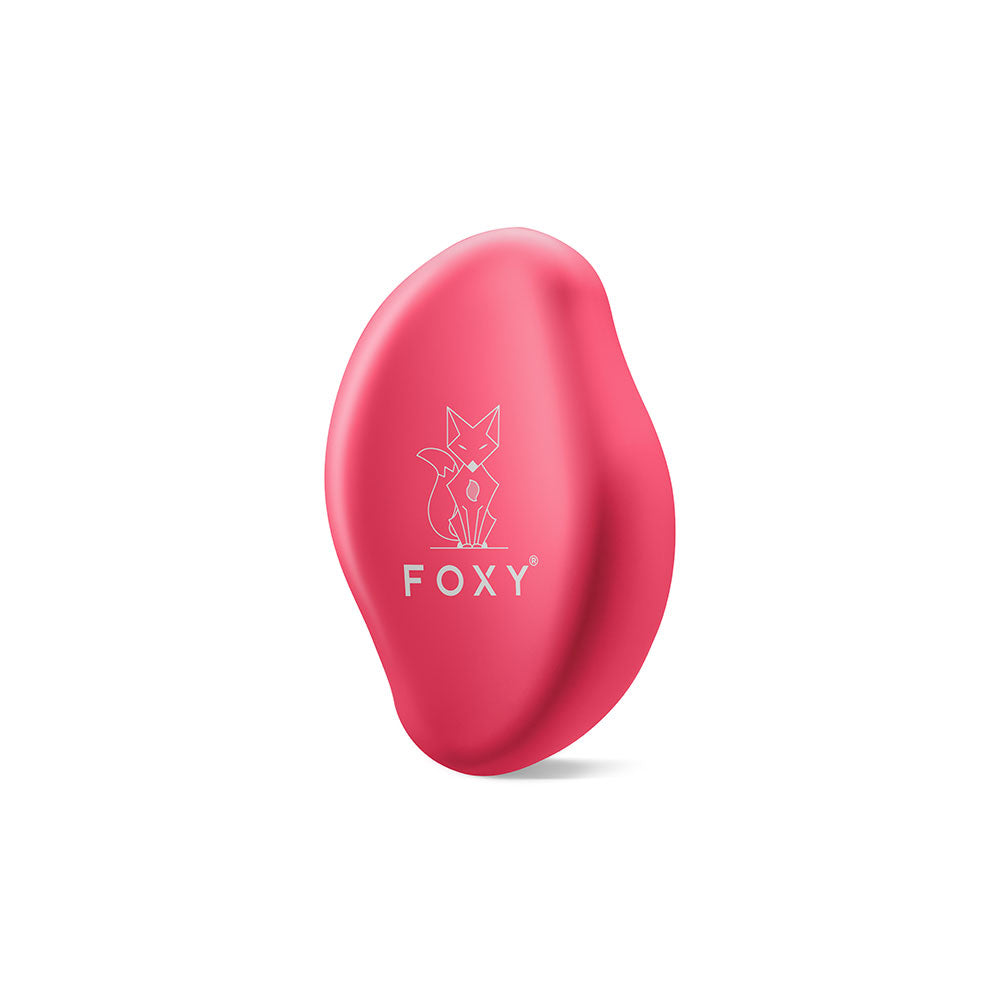 Pink, Matte, Oval-shaped hair removal tool with a stylized fox logo and the word FOXY printed on it.
