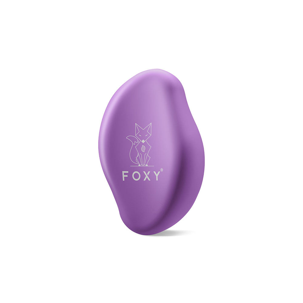 Purple, Matte, Oval-shaped hair removal tool with a stylized fox logo and the word FOXY printed on it.